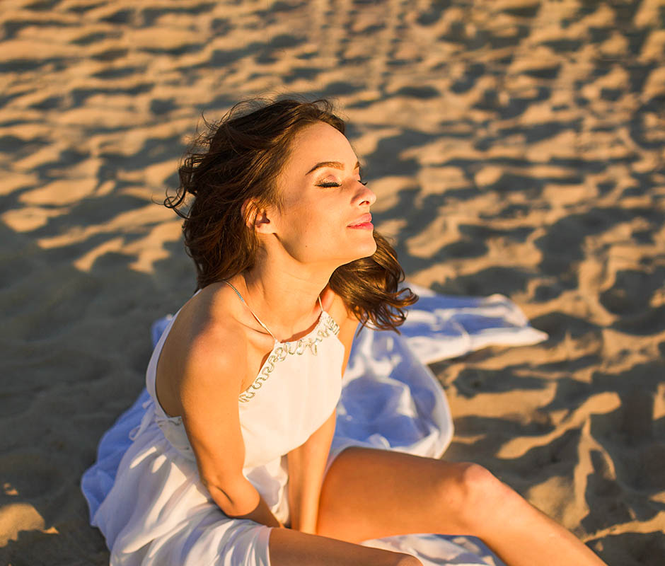 Image of woman sunning on beach. Lower Bad Cholesterol with Vitamin D